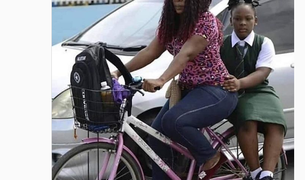 Okada Ban: Mother Takes Her Daughter To School On Bicycle
