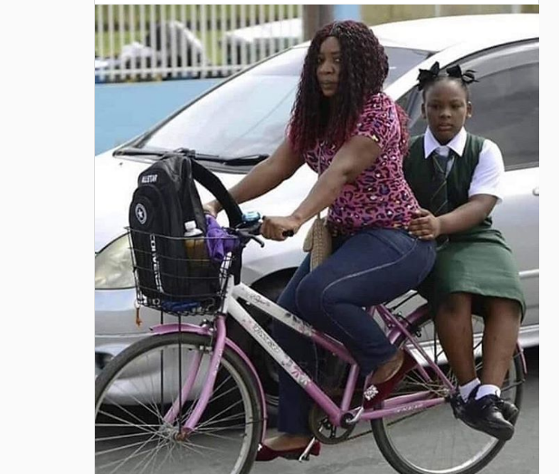 Okada Ban: Mother Takes Her Daughter To School On Bicycle