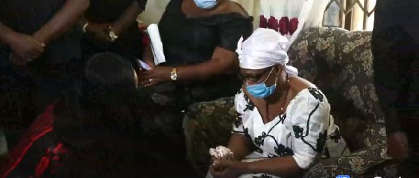 Nana Ama McBrown kneels before Bernard Nyarko’s mother at 1-week observance